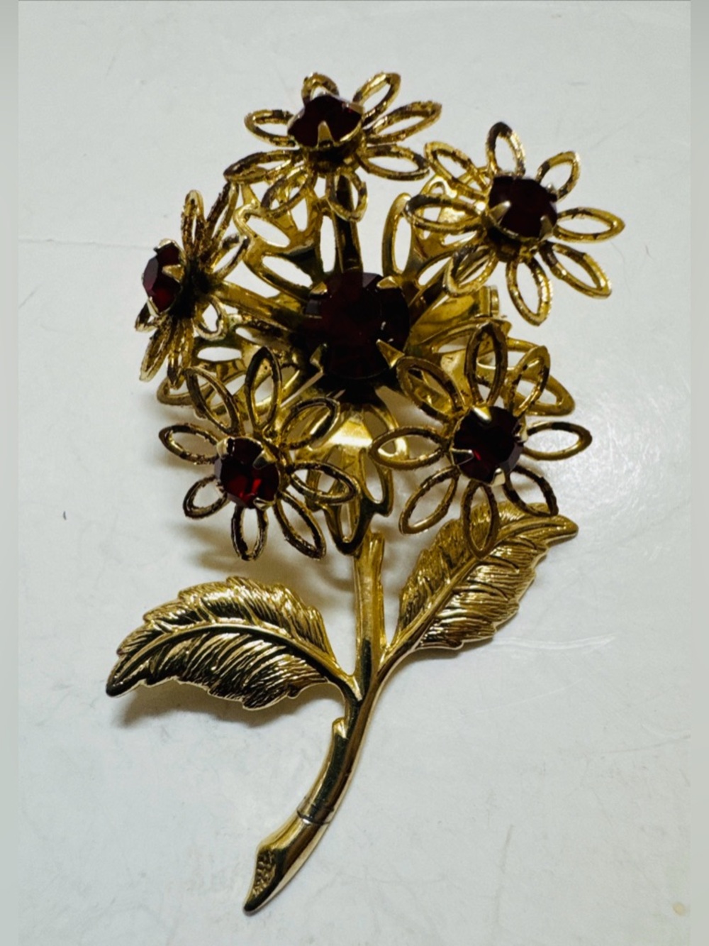 Gold Tone Floral Rhinestone Brooch with Deep Red Stones